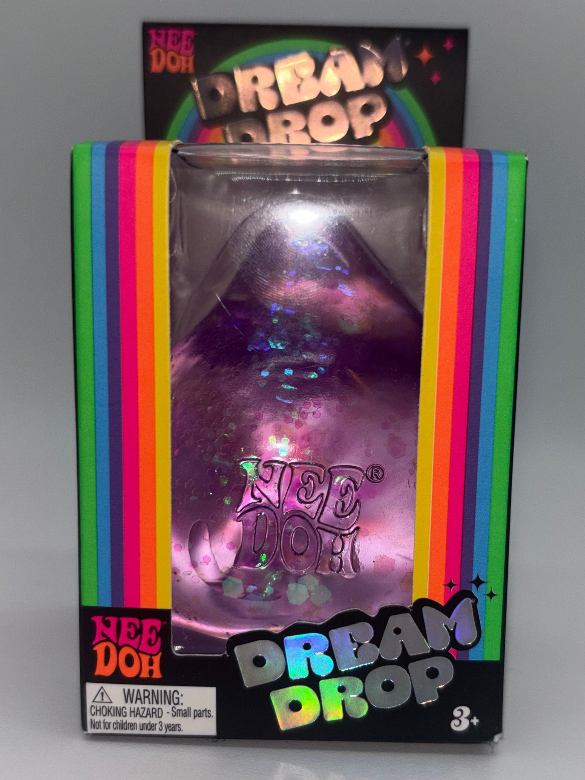 Box of 'Dream Drop' NeeDoh with colorful packaging on a gray background